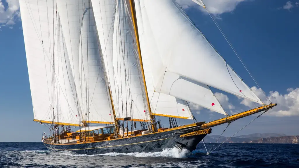 A classic schooner sailing gracefully on open waters, showcasing its dual-mast design and maritime heritage