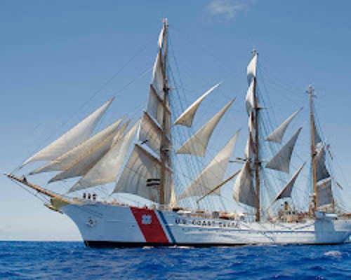 USS Eagle sailing in open waters, displaying her four-masted barkentine rigging
